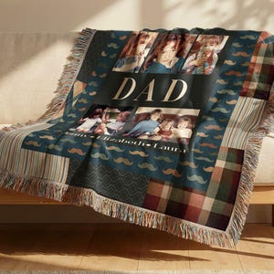 May include: A woven throw blanket featuring a dark blue background with a repeating mustache pattern, plaid sections, and a central panel displaying the word DAD, three photographs of children, and the names Jenny, Elizabeth, and Laura.