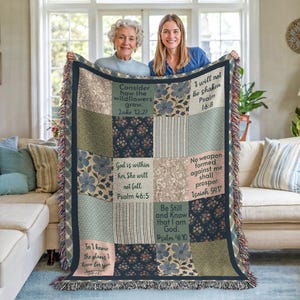 May include: A patchwork throw blanket with floral and striped patterns in shades of blue, green, and beige. The blanket features inspirational quotes from the Bible. The blanket is approximately 60 inches wide and 50 inches long.