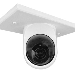 May include: A white security camera with a dark, rounded lens is mounted to a white, rectangular ceiling plate. The camera has a smooth, curved body and is designed for surveillance.