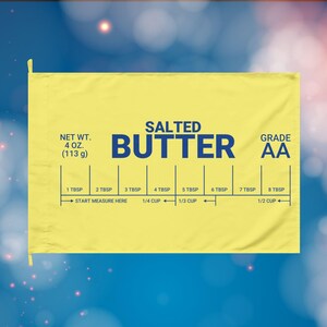 May include: Yellow butter measuring guide with the words "SALTED BUTTER" in navy blue. The guide includes measurements from 1 tablespoon to 1/2 cup, and the net weight is 113 g. The grade is AA.