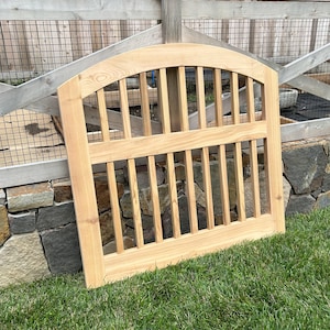 Arched exterior cedar gate with balusters