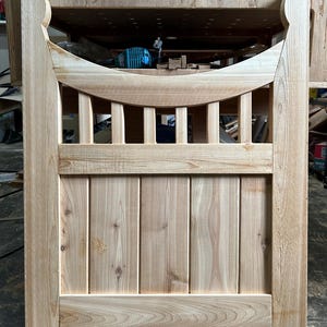 Scalloped outdoor cedar gate with tall finials