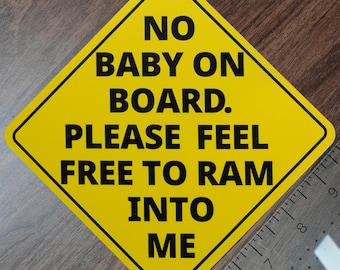 May include: A yellow diamond-shaped sign with black text that reads "NO BABY ON BOARD. PLEASE FEEL FREE TO RAM INTO ME".