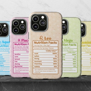 May include: Three different phone cases featuring nutrition facts labels for each of the zodiac signs: Aquarius, Pisces, Leo, Virgo, Gemini. The labels are in a light pink, light blue, light yellow, light green, and light orange colour. Each label has a different zodiac sign and lists different personality traits with a percentage daily value.