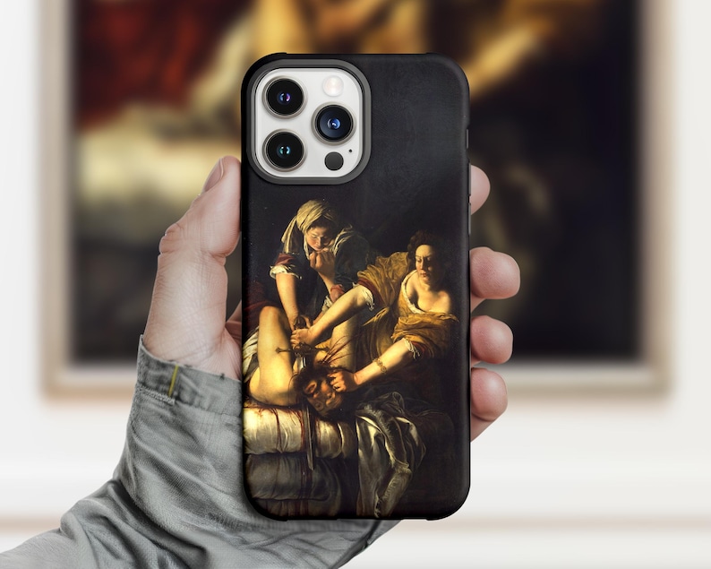 May include: Black phone case featuring a classical painting depicting a dramatic scene with figures in warm tones. The artwork is a historical painting with a dark background and detailed figures. The case has a sleek, modern design.