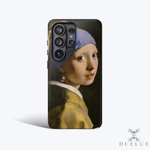 May include: A black phone case featuring a portrait of a woman with a blue headscarf and pearl earring, reminiscent of the famous "Girl with a Pearl Earring" painting. The case has a glossy finish and a camera cutout.