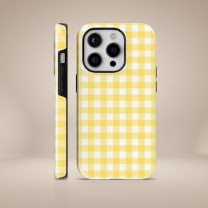 May include: A yellow and white gingham phone case for an iPhone.