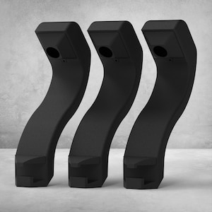 May include: Three black, curved, architectural elements. Each piece has a rectangular top with a circular opening and a square base. The curved body connects the top and base, creating a unique, modern design.