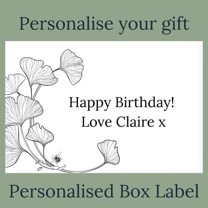 May include: A personalized box label with the text "Happy Birthday! Love Claire x". The label features a black and white illustration of ginkgo leaves and a bee. The words "Personalise your gift" and "Personalised Box Label" are also present.