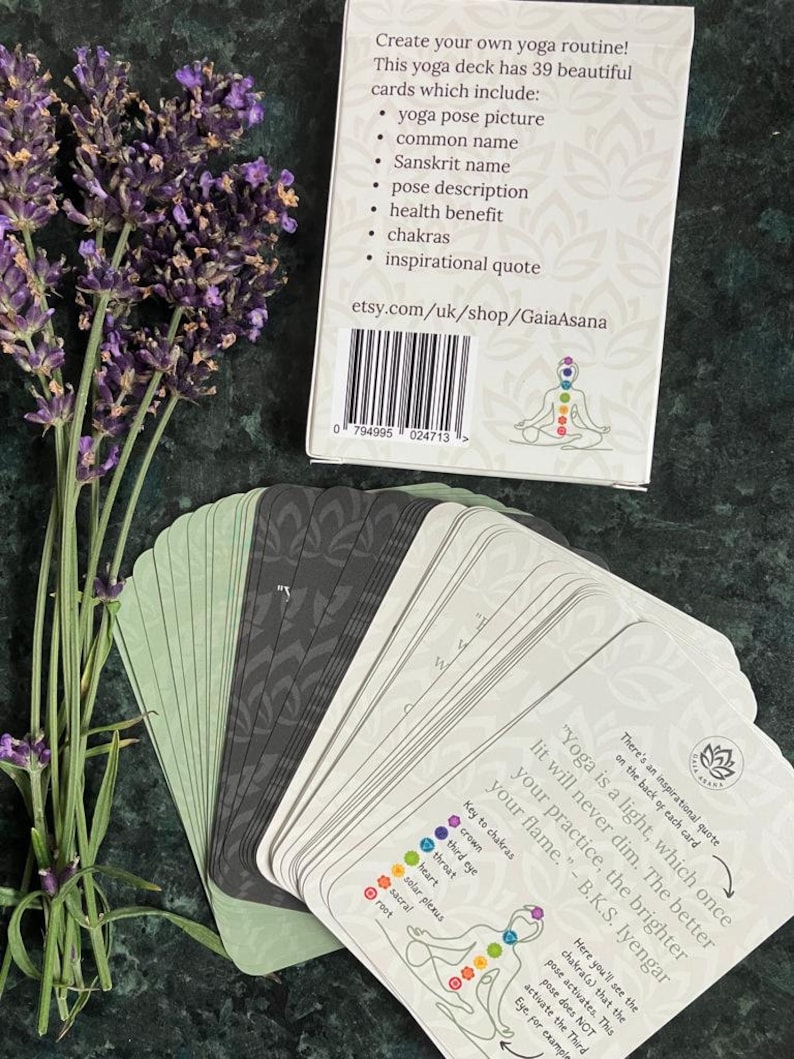 May include: A deck of 39 yoga pose cards with a colorful illustration of a person in a yoga pose on the back of the box. The box has a white background with black text that reads "Create your own yoga routine! This yoga deck has 39 beautiful cards which include: yoga pose picture, common name, Sanskrit name, pose description, health benefit, chakras, inspirational quote. etsy.com/uk/shop/GaiaAsana".
