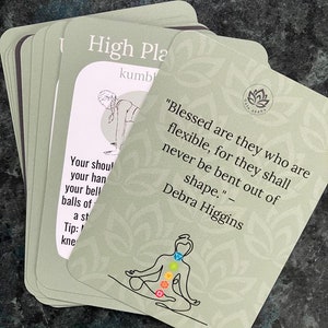 May include: A green card with a quote about flexibility and a drawing of a person in a yoga pose. The quote reads "Blessed are they who are flexible, for they shall never be bent out of shape." - Debra Higgins. The card has a lotus flower logo and the words "Gaia Asana".