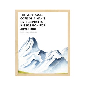 May include: A framed print featuring a watercolor illustration of snow-capped mountains. The print includes the quote: "THE VERY BASIC CORE OF A MAN'S LIVING SPIRIT IS HIS PASSION FOR ADVENTURE." by Christopher McCandless. The frame is a light wood color.