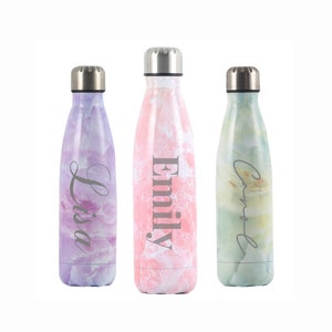 May include: Three stainless steel water bottles with marble-patterned designs. The bottles are personalised with the names "Lisa", "Emily", and "Carol".