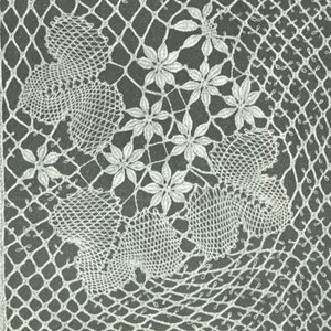 May include: A close-up of a white crocheted lace pattern with a floral design. The lace is on a gray background and the text "21 VUOKKOKIMPPU Janka n:o 70-100 56 paria" is printed below the lace.