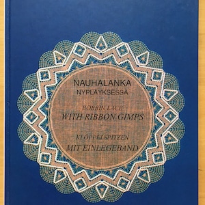 May include: A blue book cover with a white lace doily design. The title of the book is "Nauhalanka Nypläyksessä" with the subtitle "Bobbin Lace with Ribbon Gimps" and "Klöppelsitzen mit Einlegeband".