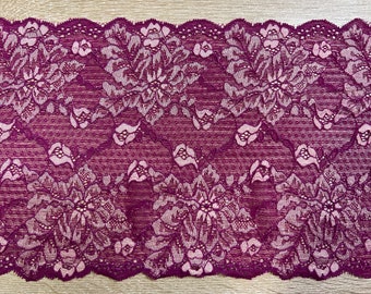 May include: Purple lace trim with a floral pattern. The lace has a scalloped edge.