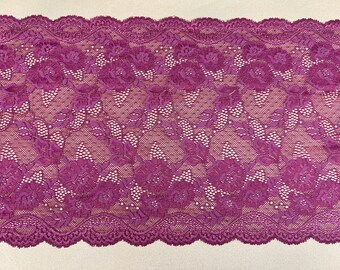 May include: Purple lace trim with a floral pattern. The lace has a scalloped edge.