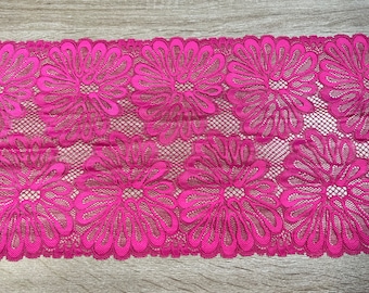 May include: Pink floral lace trim with a delicate pattern. The lace is soft and stretchy, making it perfect for adding a touch of elegance to any project.