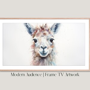 May include: A watercolor painting of a llama with a light brown, white, and blue color scheme. The llama is looking directly at the viewer with a friendly expression. The painting is framed in a light wood frame. "Modern Audience | Frame TV Artwork" is printed below the image.