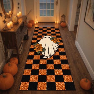 May include: A rectangular runner rug featuring a black and orange glittery checkered pattern. Centered on the rug is a white ghost illustration adorned with orange and yellow flowers with green leaves, creating a festive seasonal floor covering.