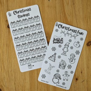 May include: Two printable sheets of Christmas themed stickers. The first sheet has 36 outlined gift boxes with the text "Christmas Savings". The second sheet has 12 outlined Christmas icons including a train, elf, snowman, gingerbread man, and a Christmas tree. The text "Christmas Fun" is at the top of the sheet. The text "Icons= £10" and "Snowflakes= £5" is at the bottom of the sheet.