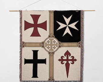 May include: Woven wall hanging featuring four quadrants with different cross designs in red, black, and white. The crosses include a Maltese cross, a cross pattée, a cross of Santiago, and a black cross. The background is beige with tan and brown accents.
