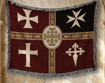 May include: A woven throw blanket featuring a dark red and black background with a central gold-toned cross emblem. The design includes four distinct white cross symbols in the corners, separated by a decorative gold-toned horizontal band with fringe.