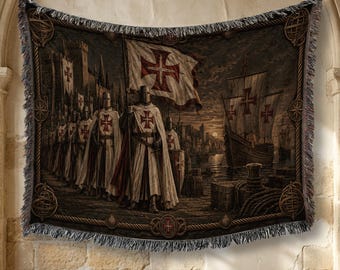 May include: A woven tapestry blanket featuring a historical scene of knights in white tunics with red crosses, carrying a flag with a red cross. The scene includes a stone castle, a wooden sailing ship on water, and a decorative border with rope motifs.