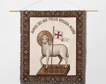 May include: A woven wall hanging featuring a lamb holding a flag with a cross. The lamb stands on a book with circular designs. The text "AGNUS DEI QUI TOLLIS PECCATA MUNDI" is in a circular pattern around the image. The border has a detailed geometric pattern.