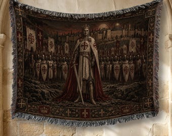 May include: A woven tapestry blanket featuring a central figure of a medieval knight in armor and a red cross cloak holding a sword, surrounded by an army with shields bearing red crosses, set against a stone city backdrop with a dark sky.