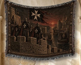 May include: A woven tapestry blanket featuring a scene of knights in dark armor standing on a stone fortress wall, holding a black flag with a white Maltese cross. The background shows a harbor with sailing ships at sunset and a coastal city.