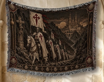 May include: A rectangular woven tapestry featuring a procession of knights on horseback carrying white flags with red crosses. The scene includes a stone castle in the background, a stone cross monument, and a decorative border with shell motifs.