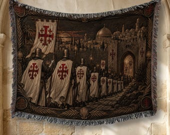 May include: A woven tapestry featuring a scene of knights in white cloaks with red Jerusalem crosses marching toward a walled city at dusk. The border includes decorative shell motifs and fringe edges, creating a detailed historical illustration.