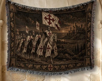 May include: A woven tapestry blanket featuring a group of knights on horseback carrying flags with red crosses. The scene depicts a procession moving toward a stone castle at sunset. The border includes oak leaf patterns and small tower motifs.