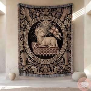 May include: A woven tapestry blanket featuring a central circular emblem of a lamb with a halo, holding a flag with a cross, resting on a book with seven seals numbered one through seven. The border displays wheat sheaves, grape vines, and birds.