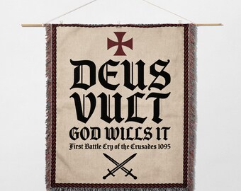 May include: A beige wall hanging with the words "DEUS VULT" in large black gothic lettering, with "GOD WILLS IT" below. A red cross and crossed swords are also featured. The banner is trimmed with a dark red border and fringe.