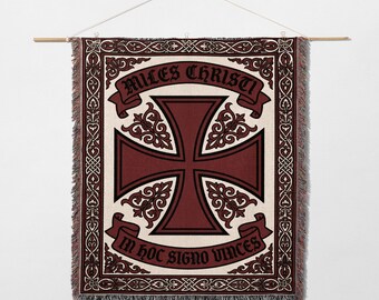 May include: Woven wall hanging featuring a burgundy Maltese cross design with the text "MILES CHRISTI" and "IN HOC SIGNO VINCIS" on banners. The cross is set against a cream background, framed by an ornate border.