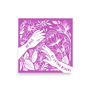 May include: White silhouette of two hands reaching up with the text "We rise by lifting others" on a pink background with white floral designs.
