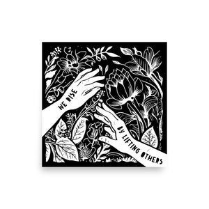 May include: Black and white illustration of two hands reaching up, surrounded by stylized flowers and leaves. The text "WE RISE BY LIFTING OTHERS" is written on the hands.
