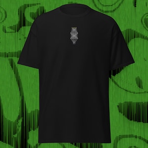 May include: Black t-shirt featuring a small, embroidered design on the chest. The design is a series of interconnected lines and shapes in white, grey, and yellow. The shirt has short sleeves and is made of a soft fabric.
