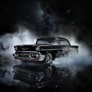 May include: A black 1957 Chevrolet Bel Air classic car with chrome accents, parked in a dark setting with a starry sky and smoke or fog surrounding it. The car is reflecting in the ground.
