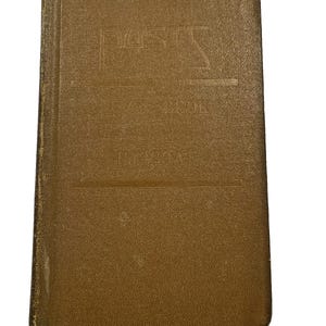May include: A vintage brown book with embossed text on the cover. The book's cover is a solid, muted brown color with a slightly textured surface. The embossed text reads "PASS" and "NOTE BOOK".