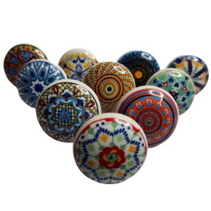May include: Assortment of ten colorful ceramic cabinet knobs with intricate geometric patterns in shades of blue, red, green, yellow, and white.