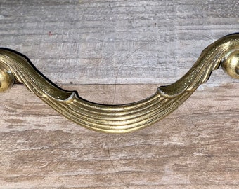 Vintage Burnished brass drawer handle or cabinet pull knob with a scroll end design. Marked 1999 KBC 48877.