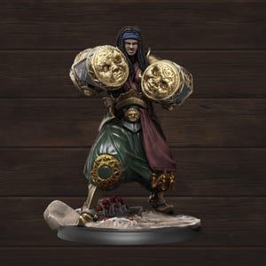 May include: A detailed figurine of a warrior with dreadlocks, wearing a blue headband, and holding two large, ornate golden gauntlets. The figure is dressed in green pants, a burgundy sash, and gold accents. The base is a dark gray with a textured surface.