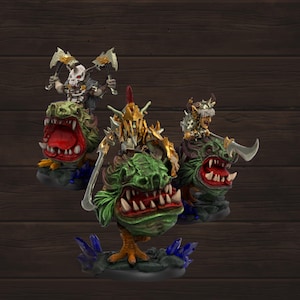 May include: Three fantasy figurines featuring green, toothy creatures with riders. The riders are clad in armor and wielding weapons. The creatures have open mouths with red interiors and are mounted on bases with blue crystal accents.