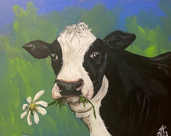 Vache à manger sur une marguerite