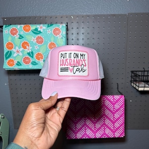 Put It On My Husband’s Tab,Embroidered, Pink,Patch, SnapBack, Trucker Hat