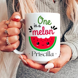 May include: White ceramic mug with a watermelon graphic and the text "One in a melon" and a personalized name "Priscilla".
