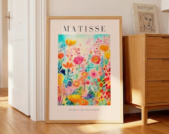 May include: A framed vertical art print featuring a colorful floral illustration with shades of pink, orange, and yellow. The text MATISSE is printed at the top, and the text MUSEE D'ART BOTANIQUE is printed at the bottom on a light beige background.